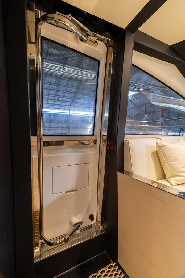 A sleek and modern interior space featuring a door with a view of the outside. aboard SABI Yacht for Sale