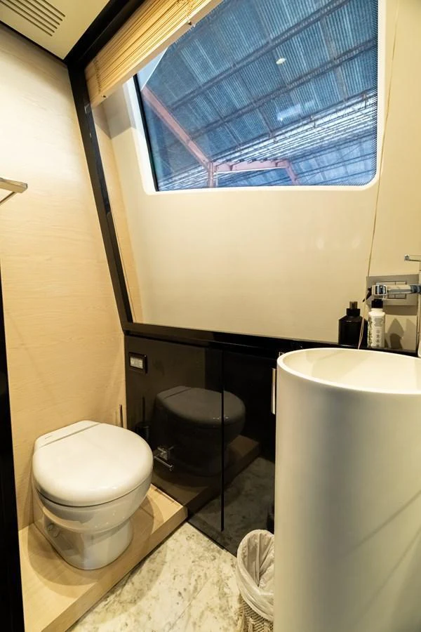 A modern yacht bathroom with a sleek design and large window. aboard SABI Yacht for Sale