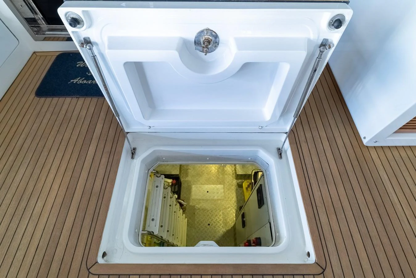 A hatch opens to reveal a well-lit access to the yacht's lower deck or engine room. aboard SABI Yacht for Sale