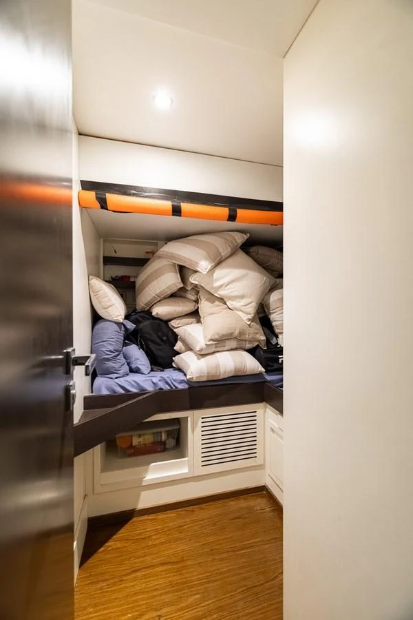 A cozy storage area filled with pillows and bedding essentials. aboard SABI Yacht for Sale