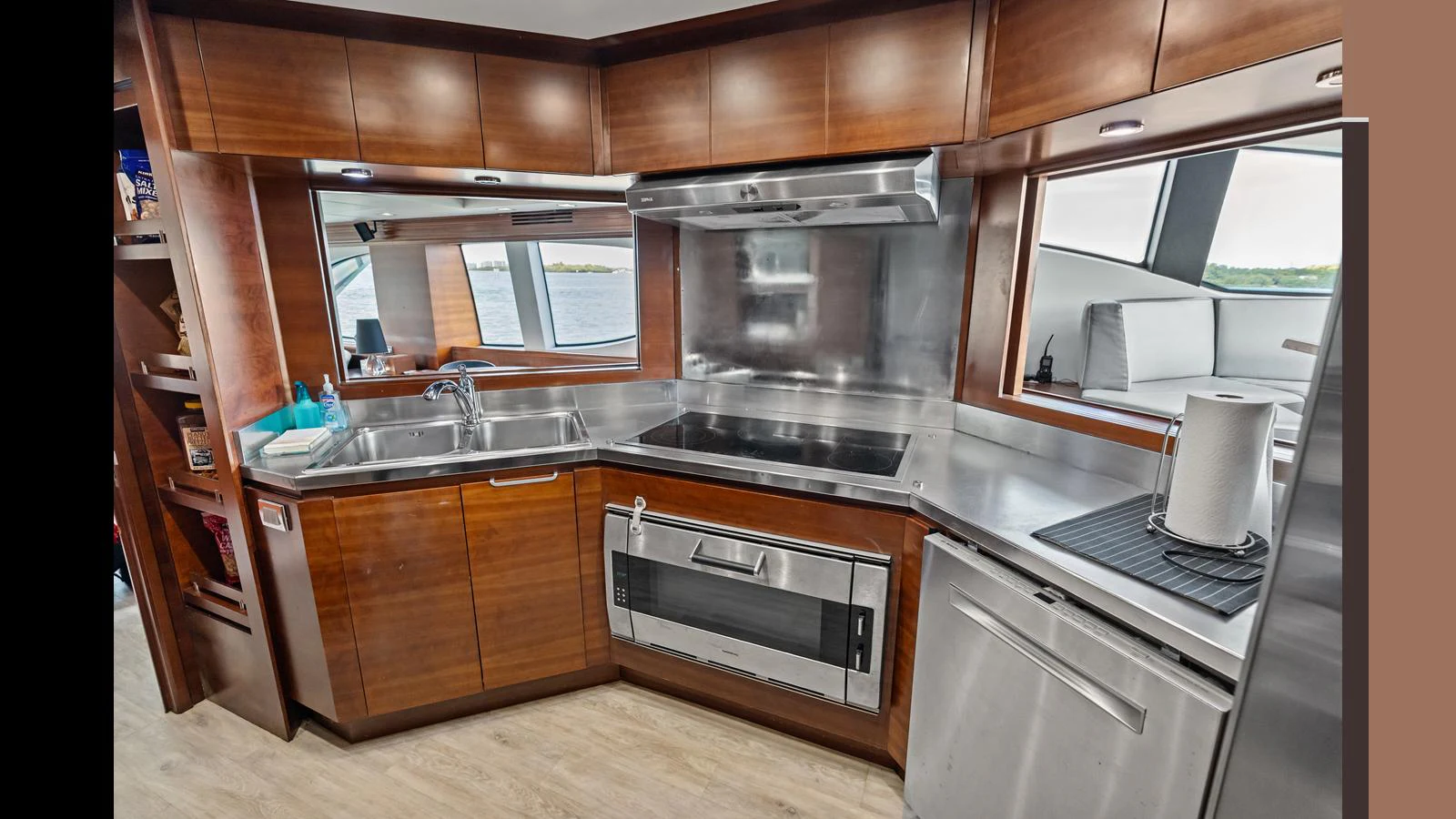 a kitchen with wooden cabinets aboard KNOT WOKE Yacht for Sale