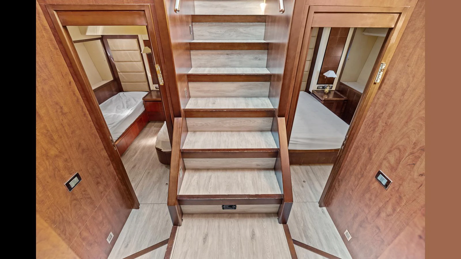 a wooden staircase with a glass door aboard KNOT WOKE Yacht for Sale