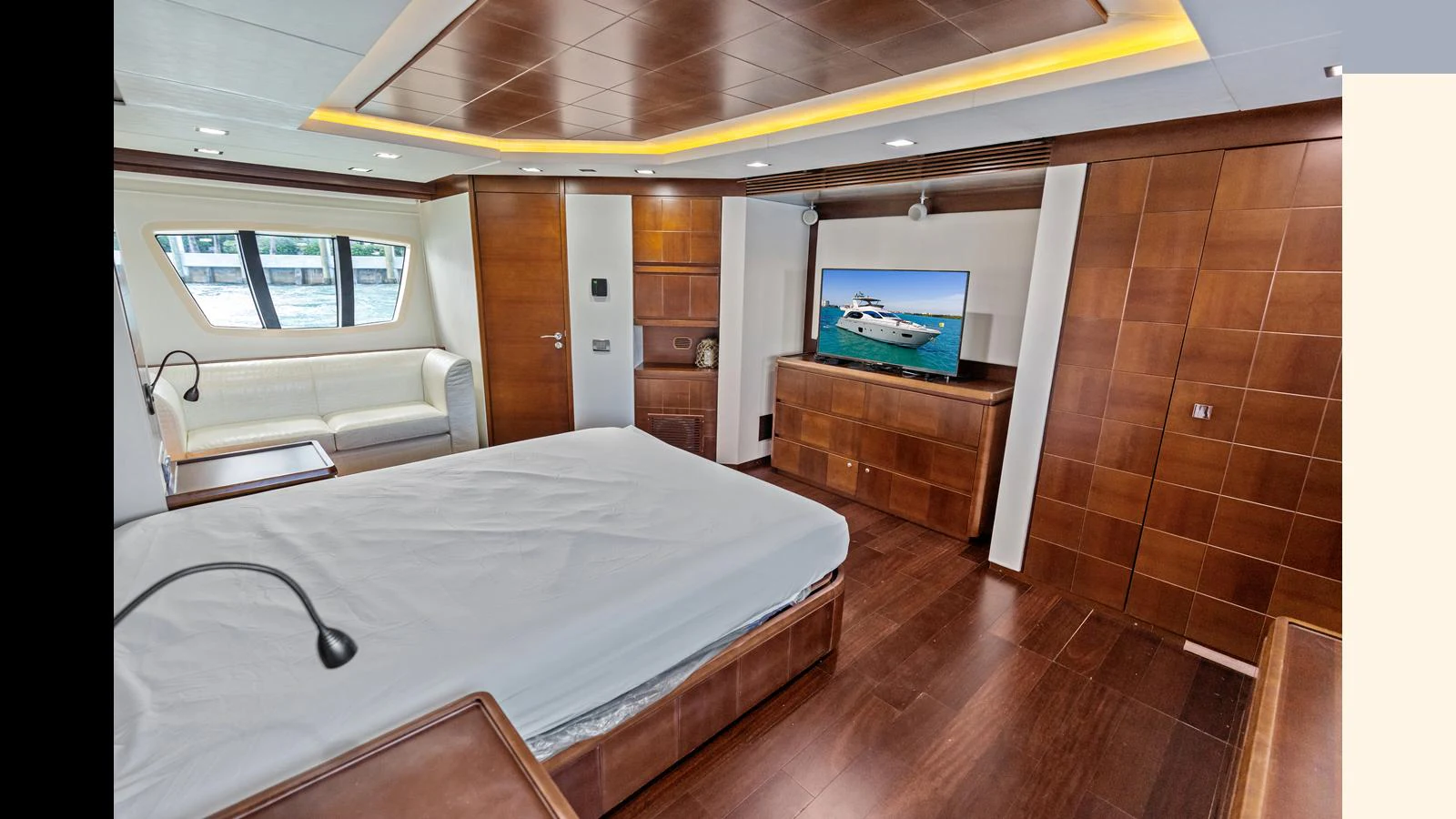 a room with a bed and a television aboard KNOT WOKE Yacht for Sale