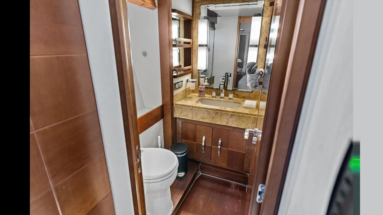 a bathroom with a sink toilet and a mirror aboard KNOT WOKE Yacht for Sale