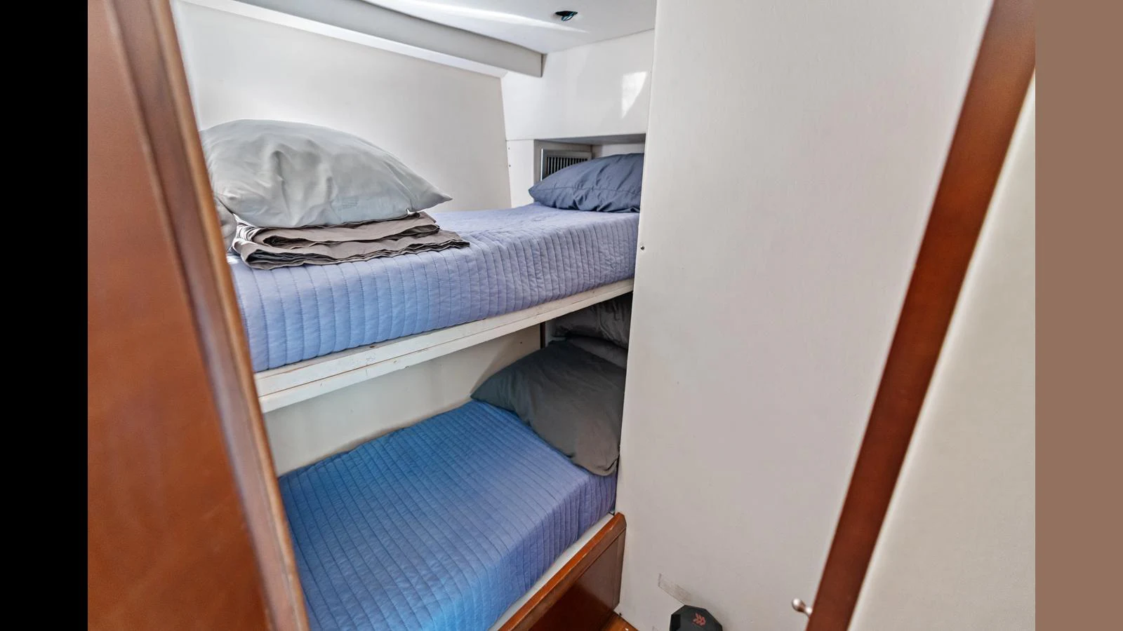 a room with a bed and a white wall aboard KNOT WOKE Yacht for Sale