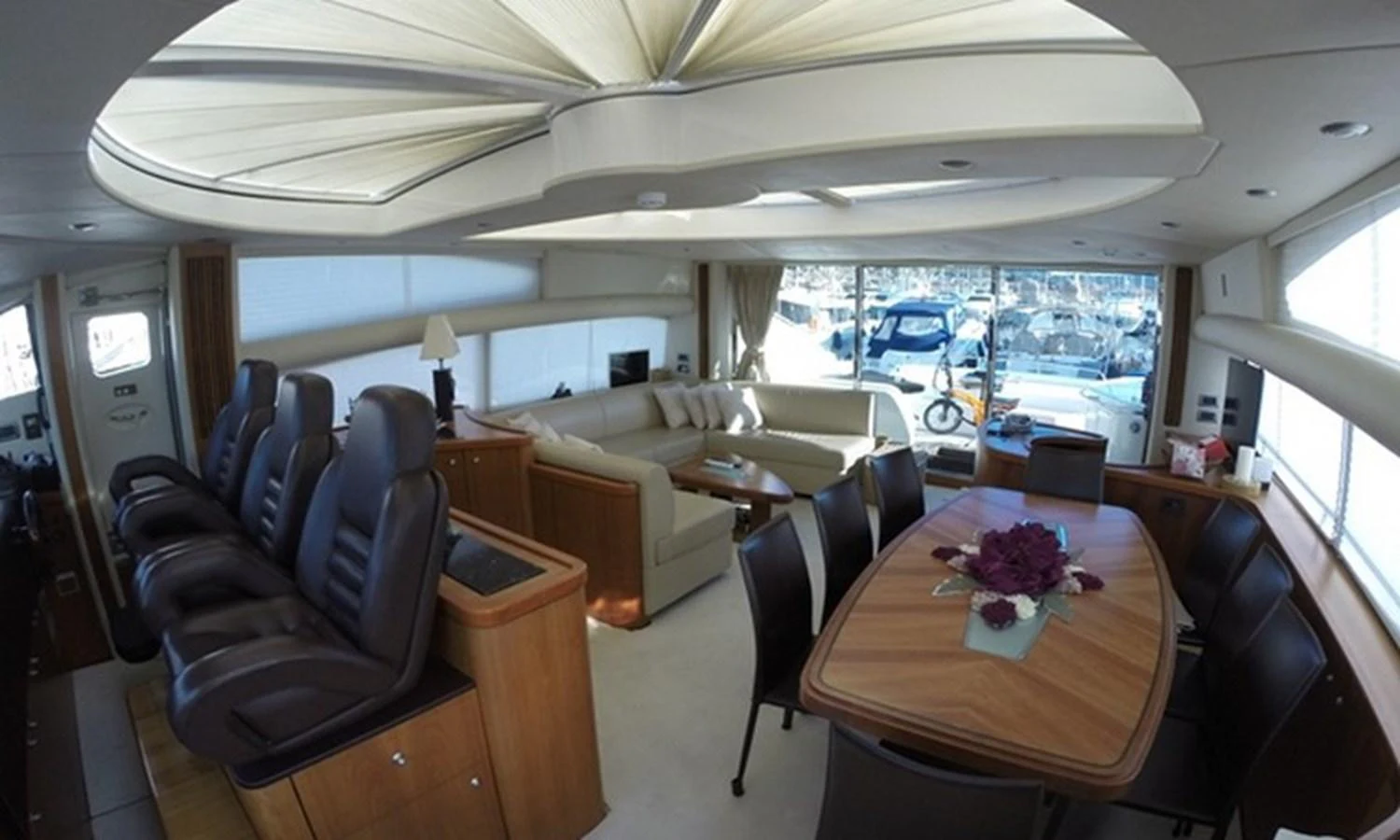 inside of a vehicle with chairs and tables and a view of the water aboard ESY Yacht for Sale