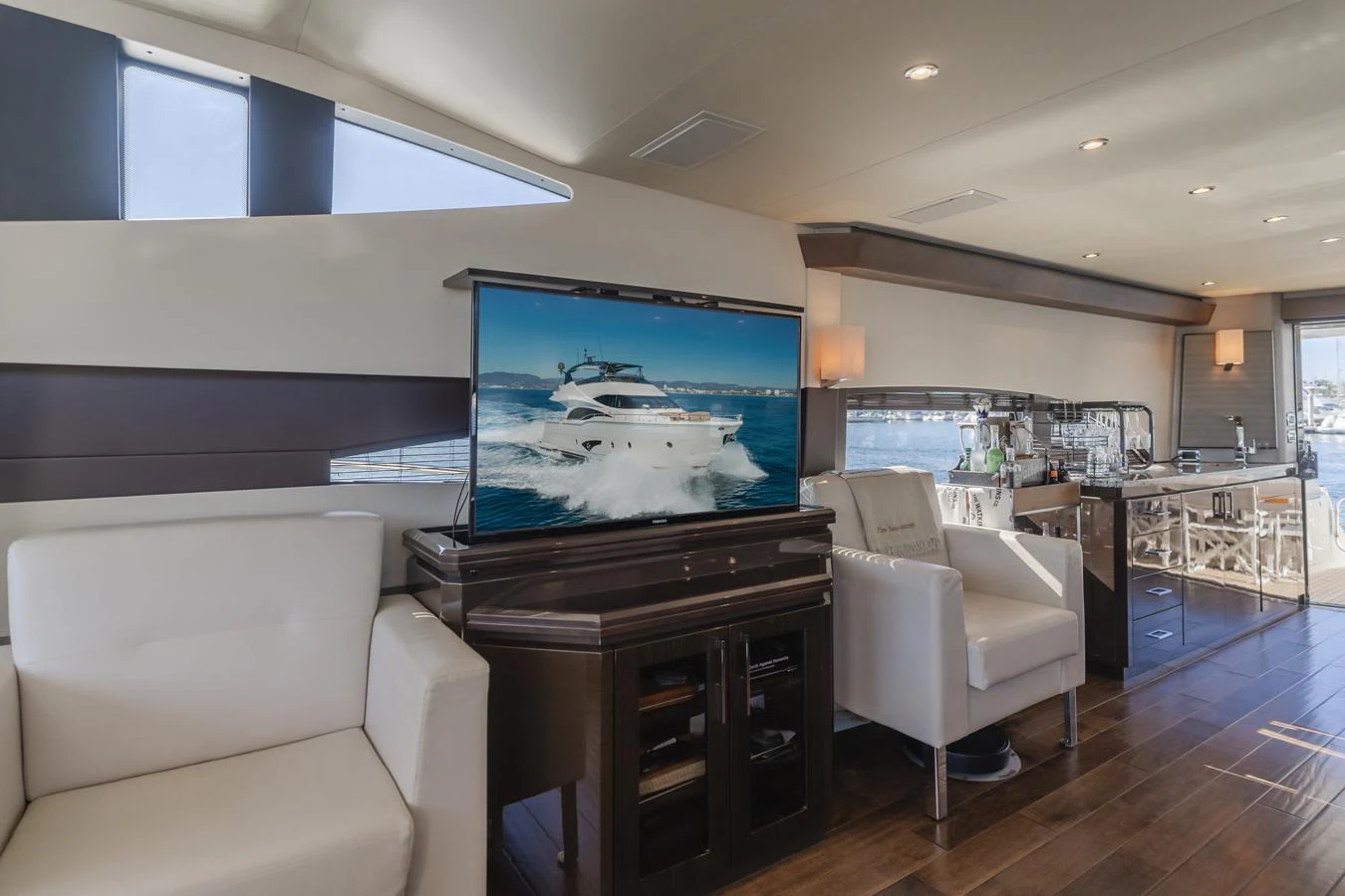 a living room with a large television aboard FINE SEAS-ONINGS Yacht for Sale