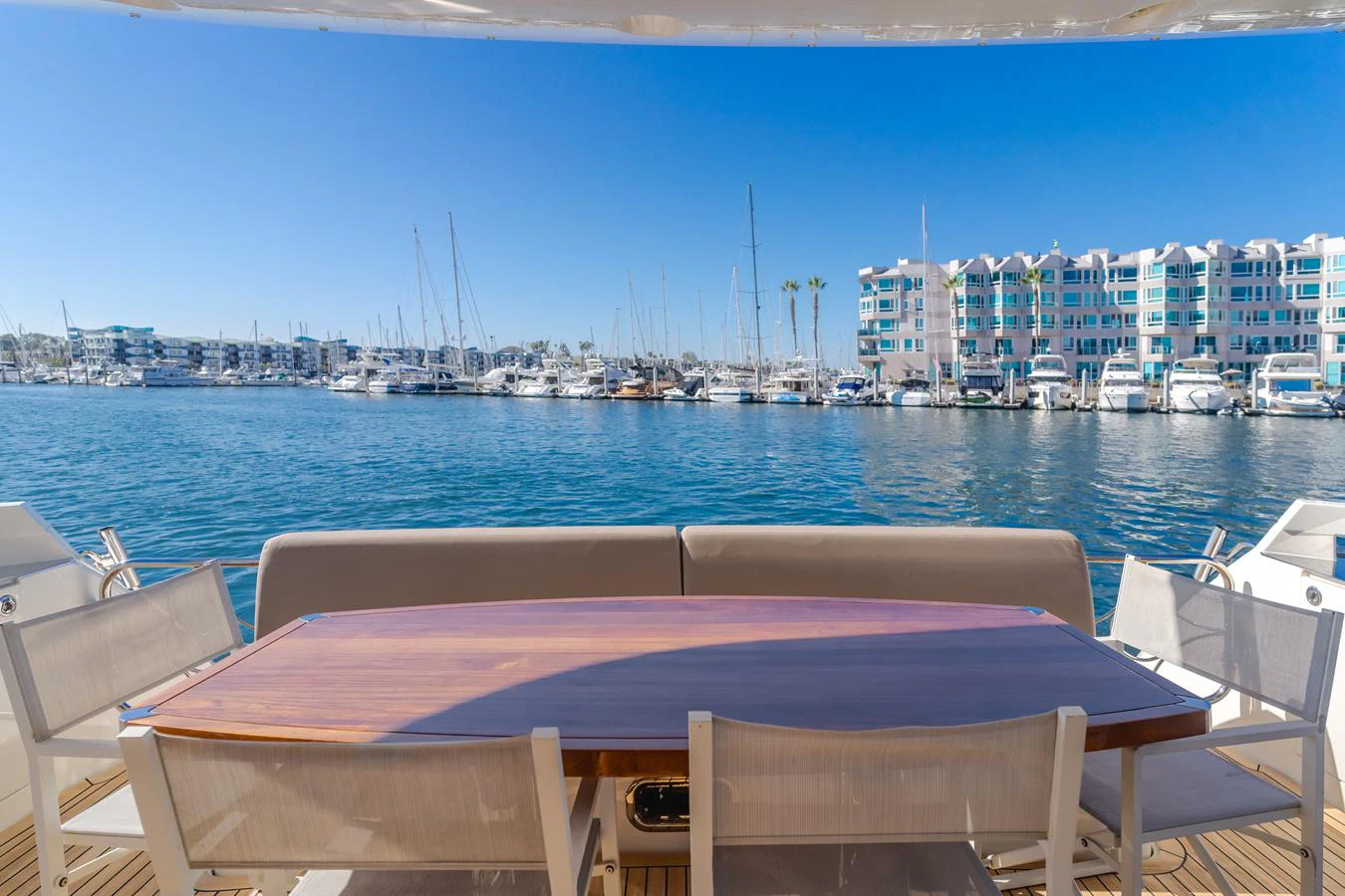 a table and chairs on a deck overlooking a body of water aboard FINE SEAS-ONINGS Yacht for Sale