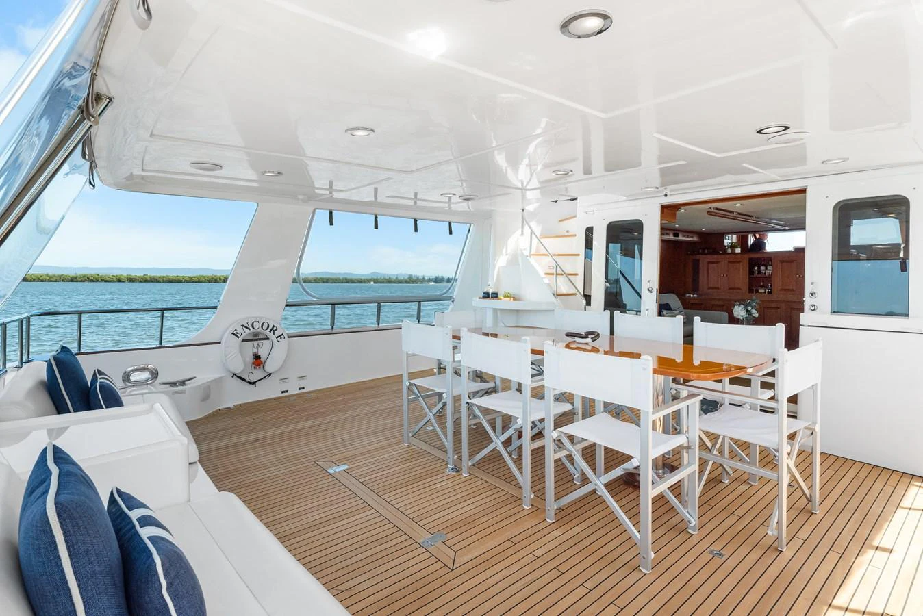 a room with a table and chairs aboard ENCORE Yacht for Sale