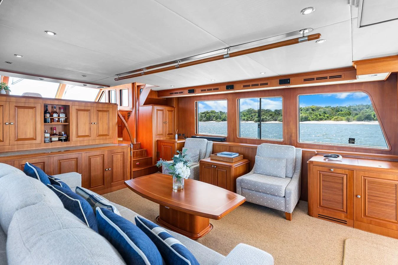 a living room with a table and chairs aboard ENCORE Yacht for Sale