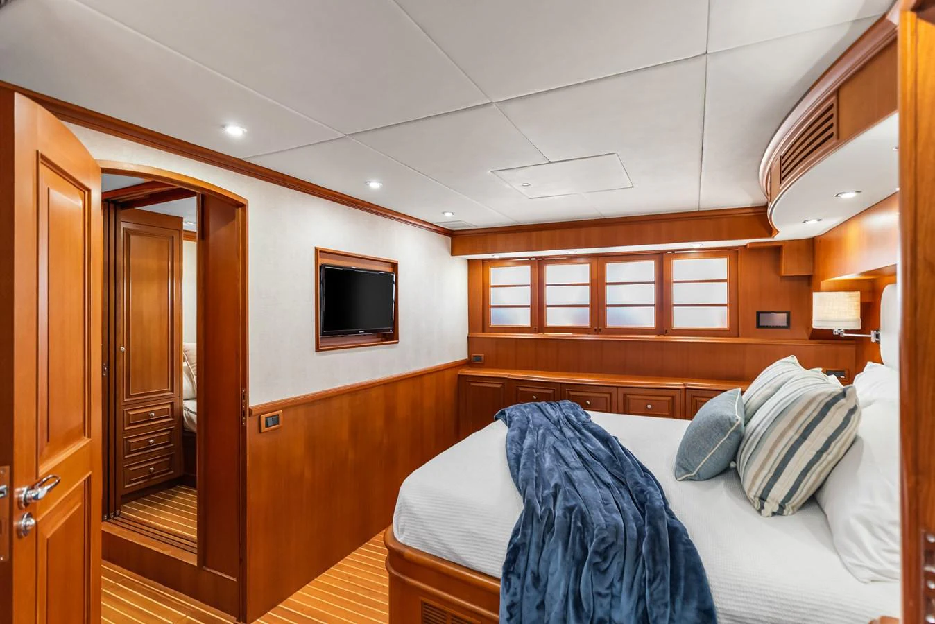 a bedroom with a bed and a television aboard ENCORE Yacht for Sale