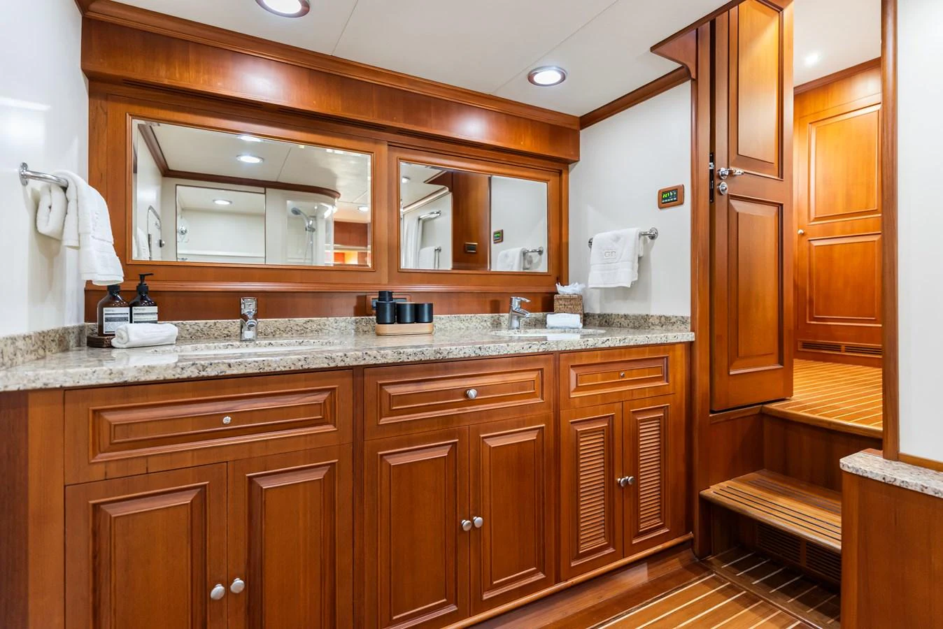 a bathroom with wooden cabinets aboard ENCORE Yacht for Sale
