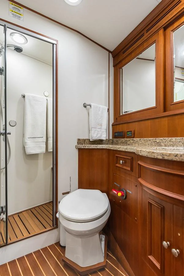a bathroom with a glass shower door aboard ENCORE Yacht for Sale
