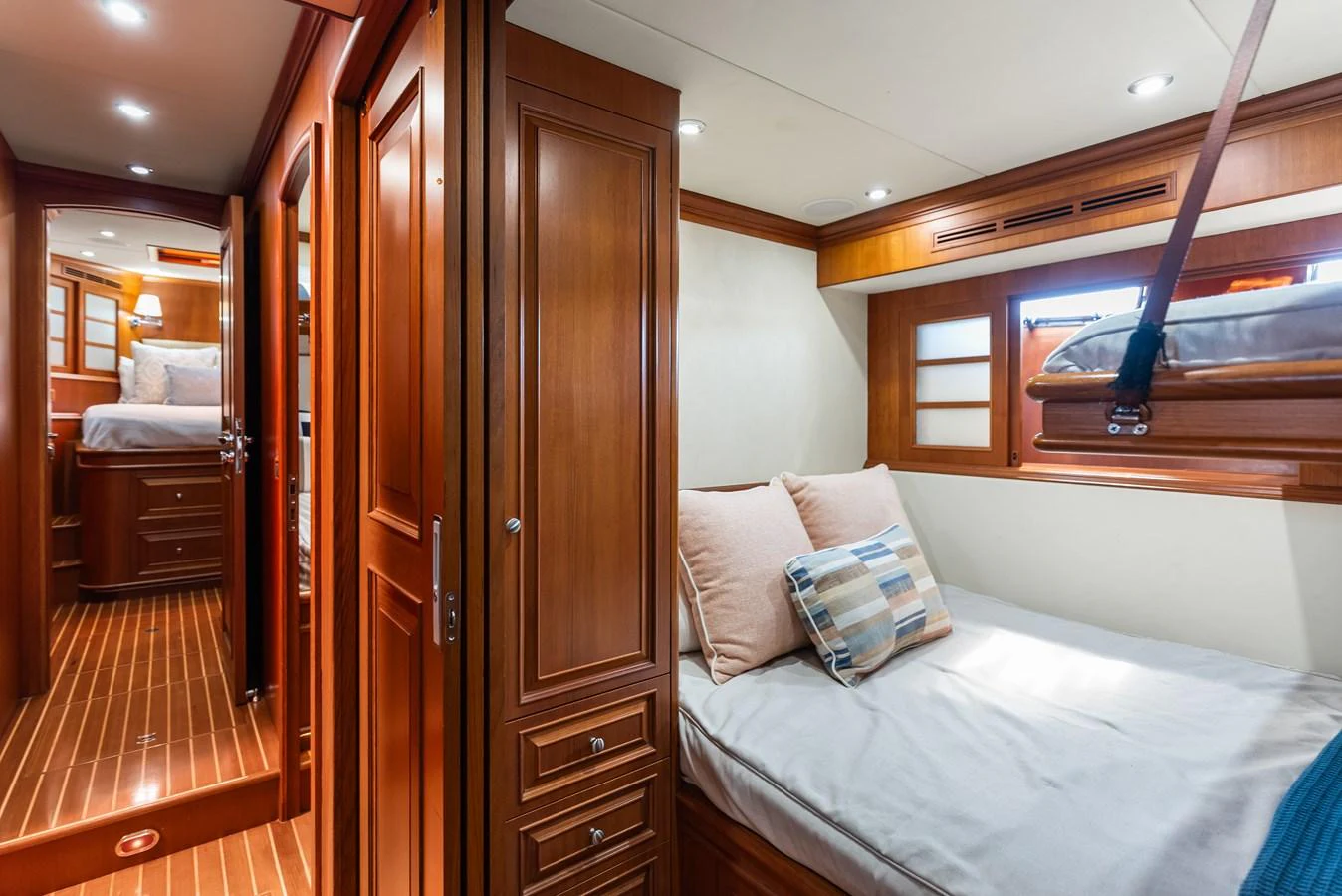 a bedroom with a bed and a wood door aboard ENCORE Yacht for Sale