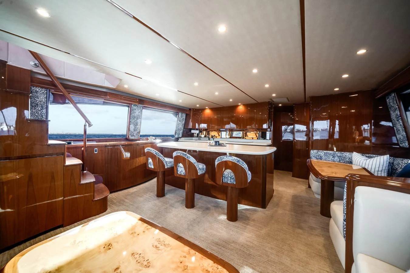 a large room with a table and chairs aboard EL JEFE Yacht for Sale