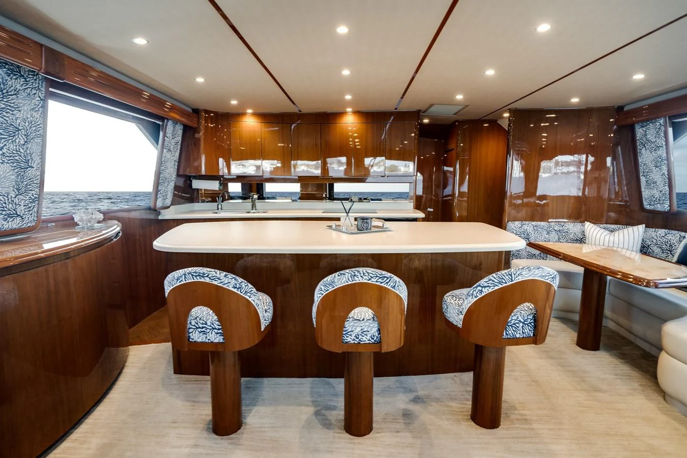 a large kitchen with a bar and stools aboard EL JEFE Yacht for Sale