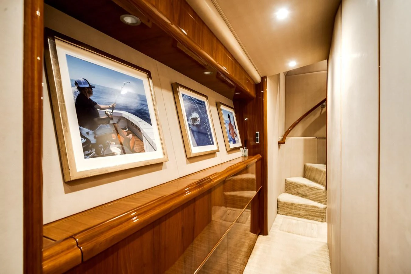 a staircase with paintings on the wall aboard EL JEFE Yacht for Sale