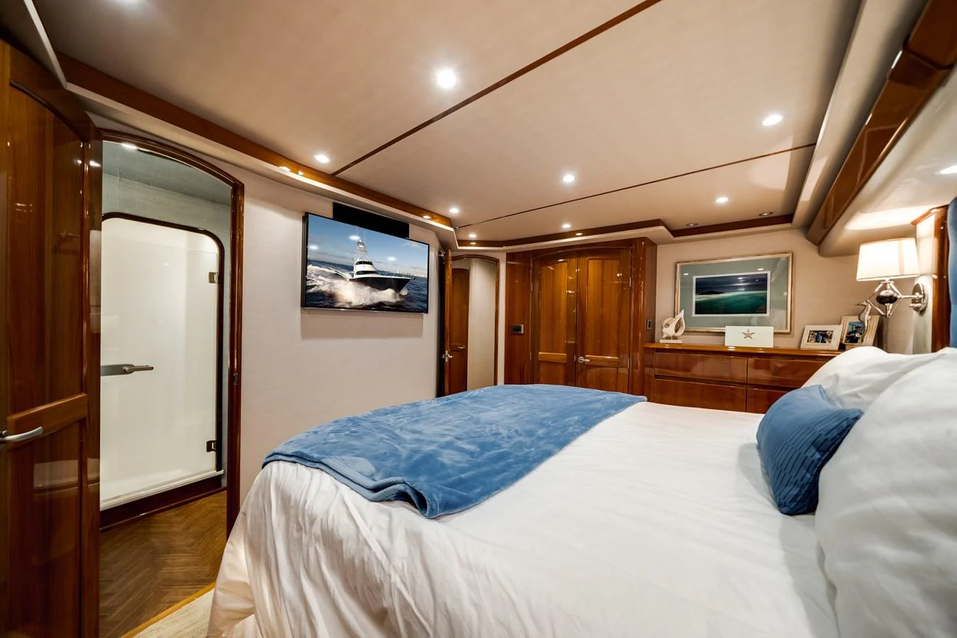 a bedroom with a bed and a television aboard EL JEFE Yacht for Sale