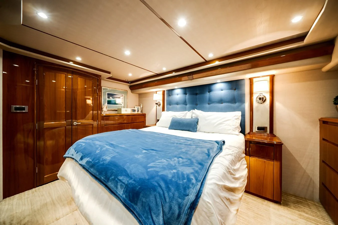 a bedroom with a bed and a closet aboard EL JEFE Yacht for Sale
