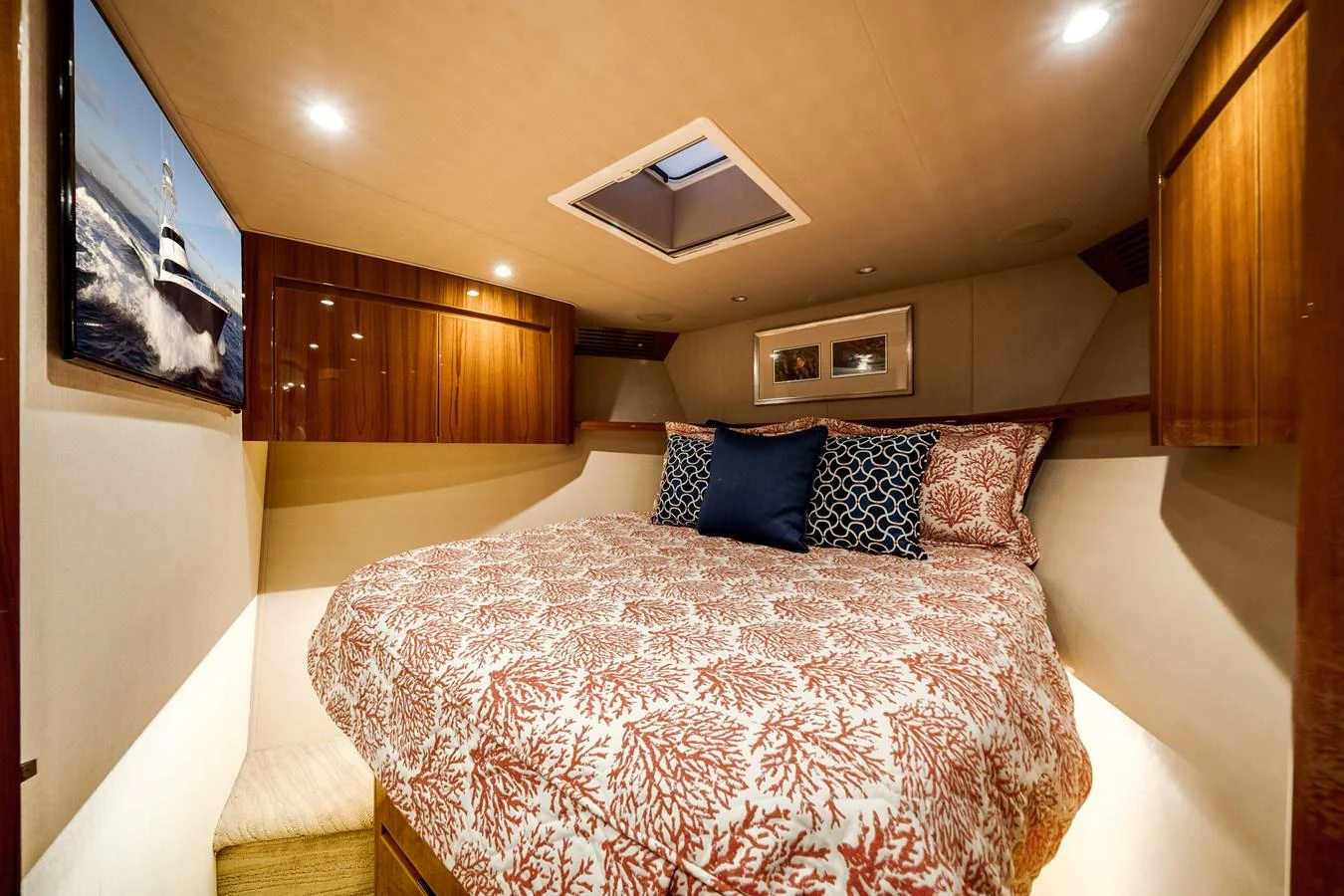 a bed with a white comforter aboard EL JEFE Yacht for Sale