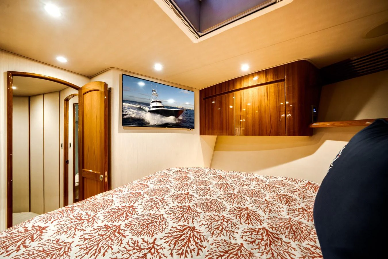 a bed with a television on the wall aboard EL JEFE Yacht for Sale