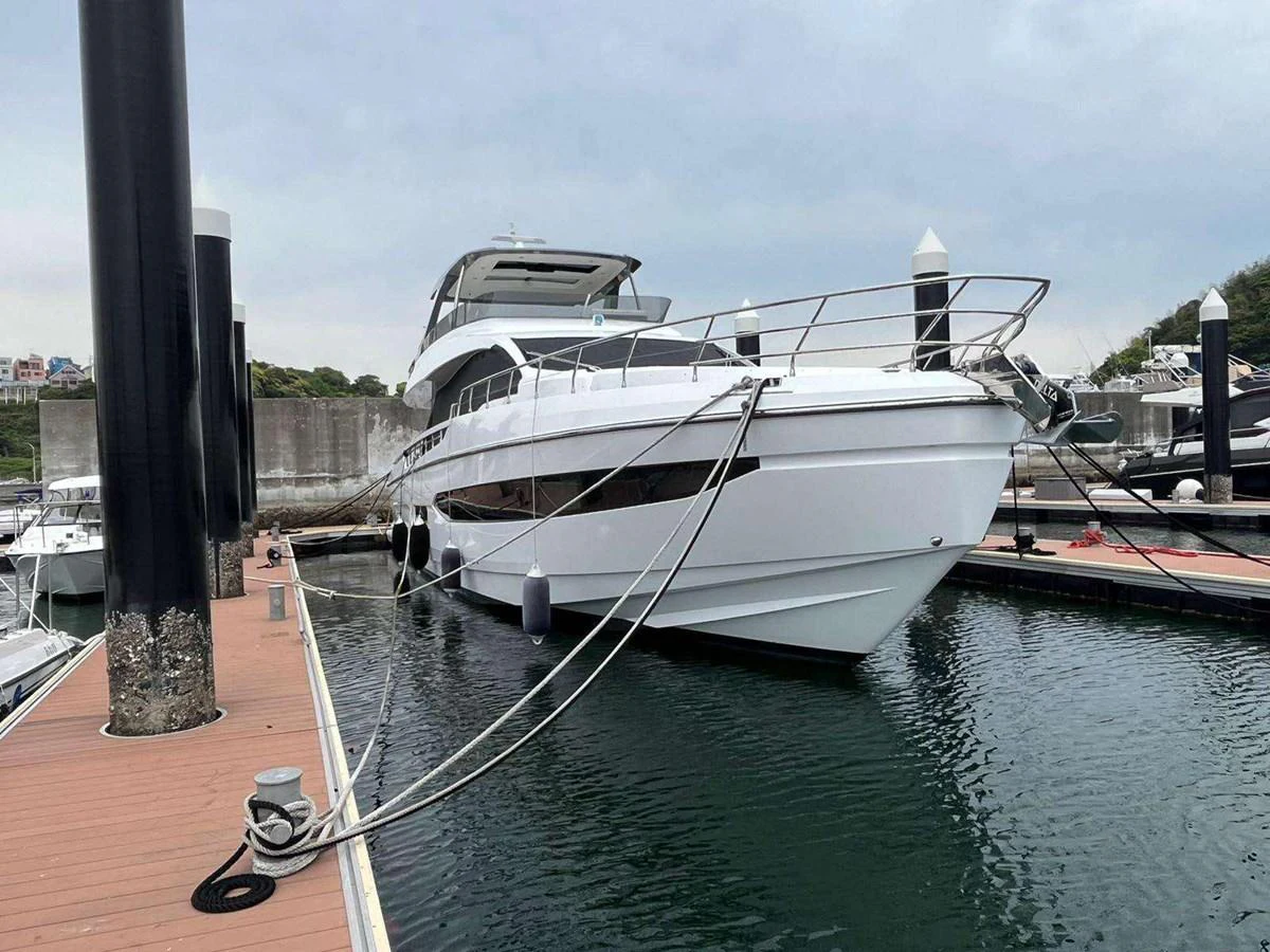 a white boat docked at a pier aboard ANGEL Yacht for Sale