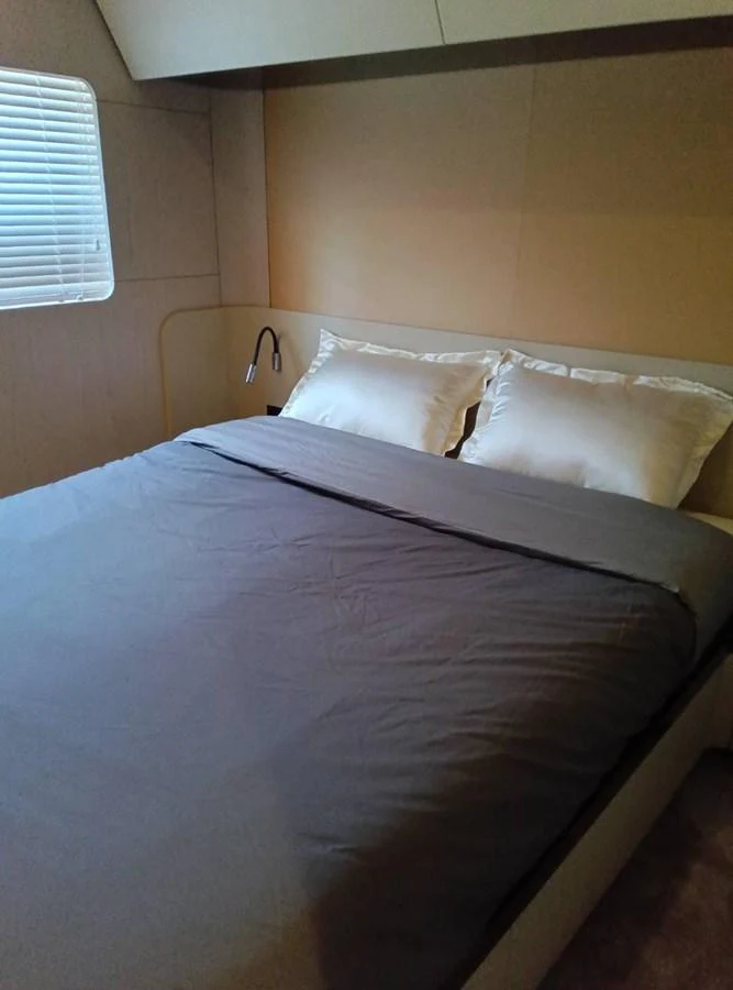 a bed with white sheets aboard ANGEL Yacht for Sale