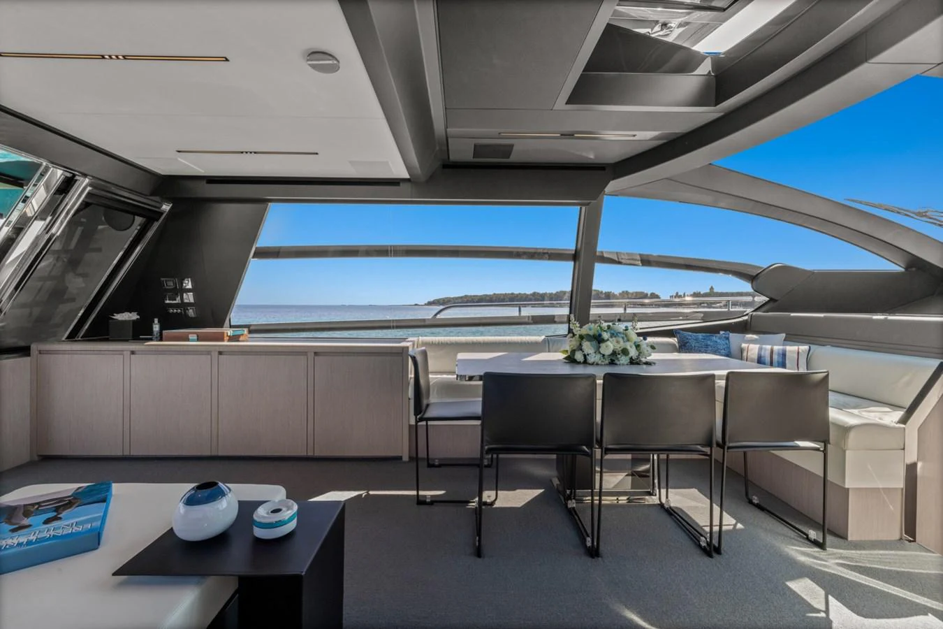a room with tables and chairs aboard SAMIRA Yacht for Sale
