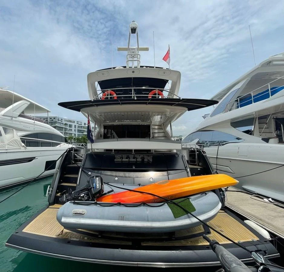 A luxurious yacht is docked at the marina, showcasing its spacious aft deck with water toys ready for adventure. aboard ELLYN Yacht for Sale