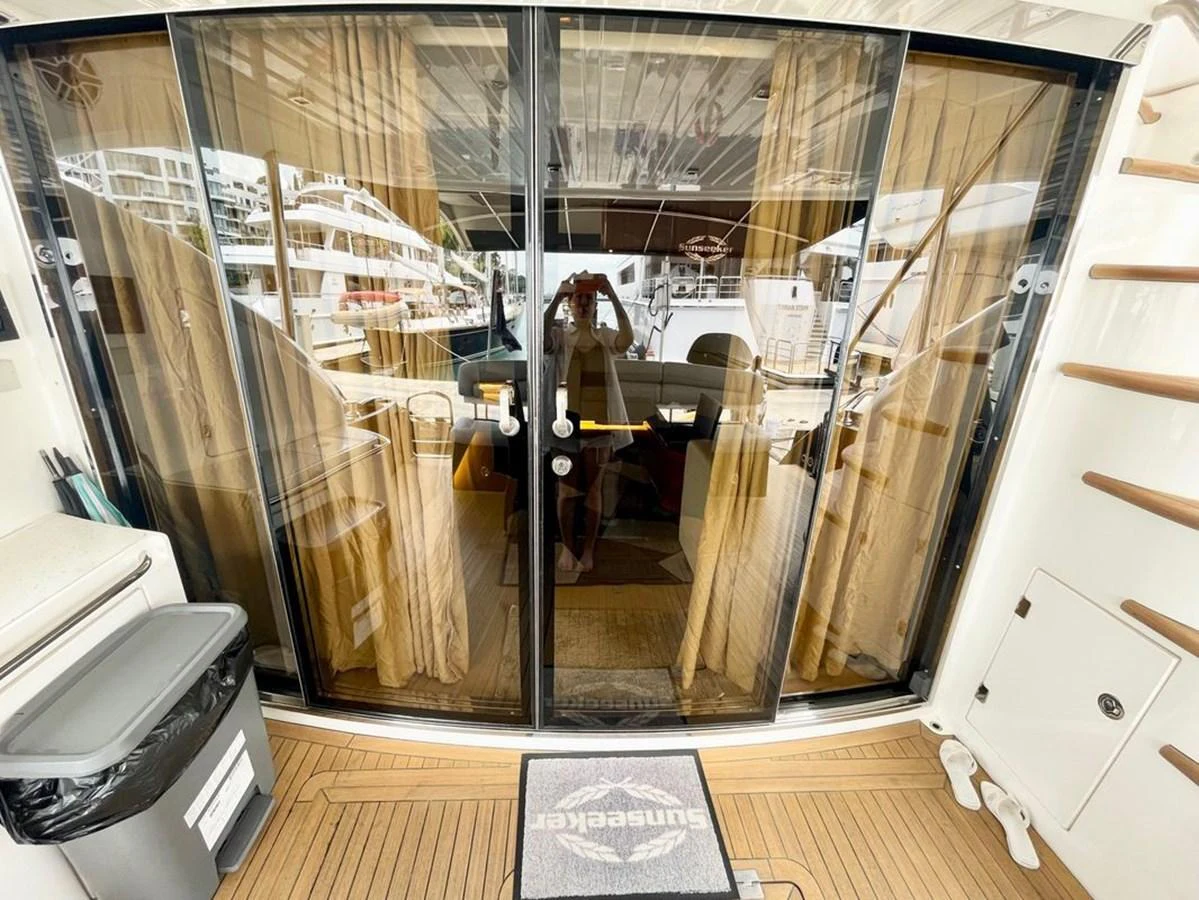 The yacht's entryway features glass sliding doors with a view of the marina. aboard ELLYN Yacht for Sale