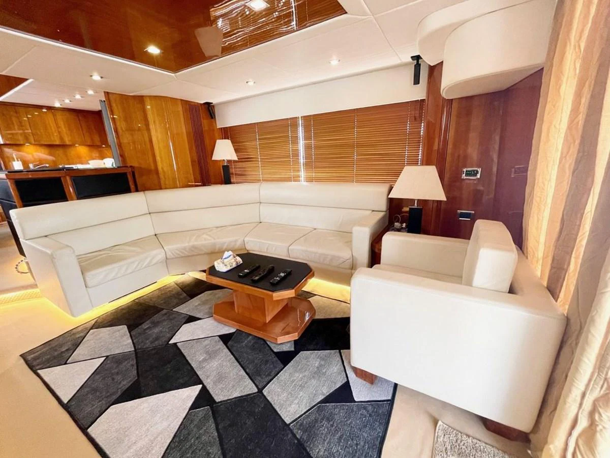 The yacht's salon features a spacious and elegant seating area with modern furnishings and warm lighting. aboard ELLYN Yacht for Sale