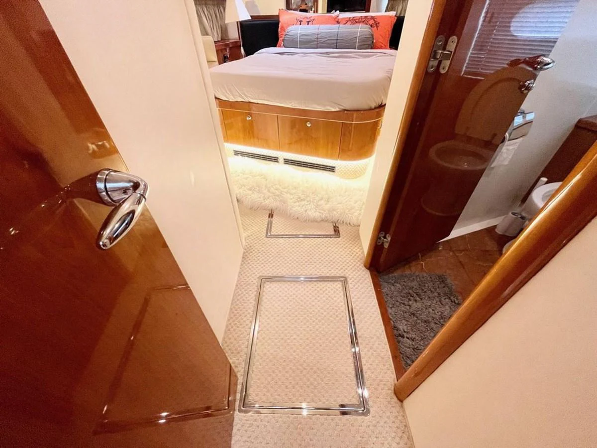 A cozy stateroom with a plush bed and warm lighting, offering a welcoming retreat. aboard ELLYN Yacht for Sale