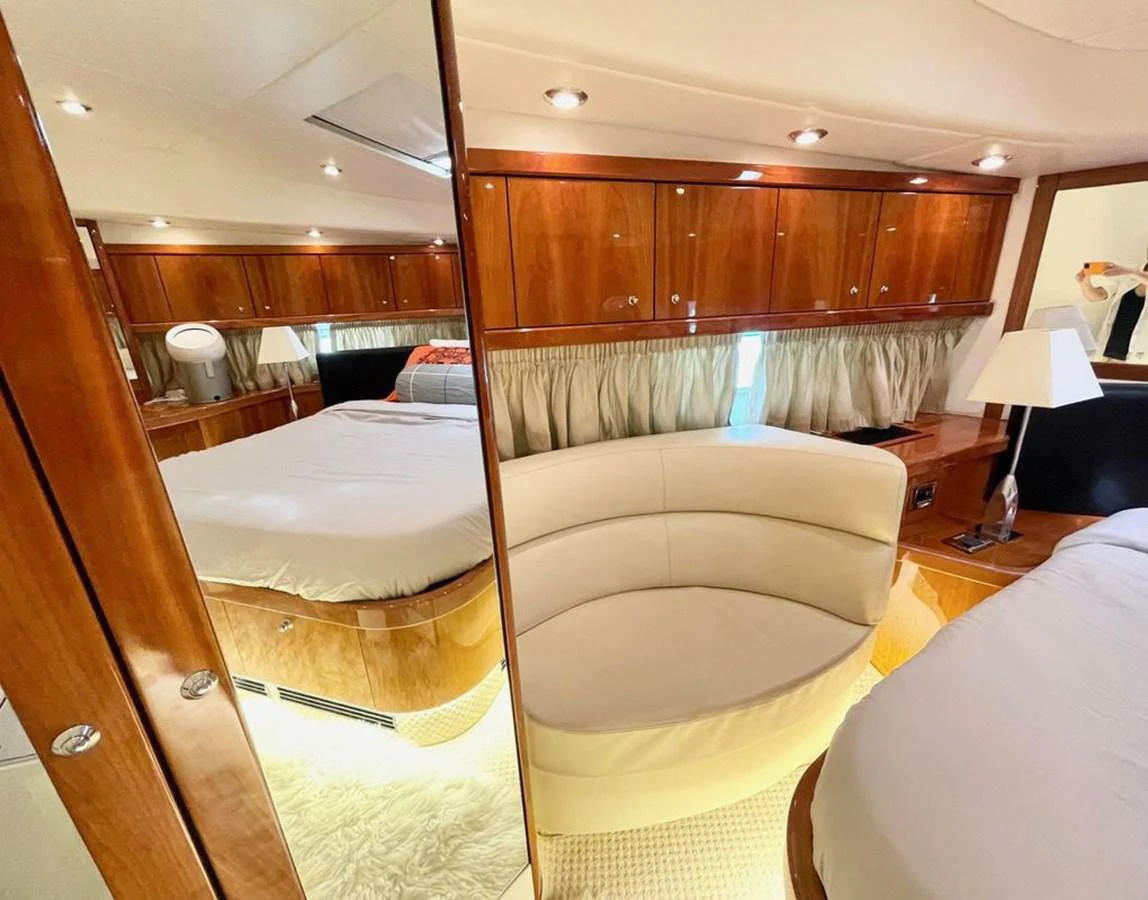 The stateroom features luxurious wood paneling and plush furnishings, creating a warm and inviting atmosphere. aboard ELLYN Yacht for Sale