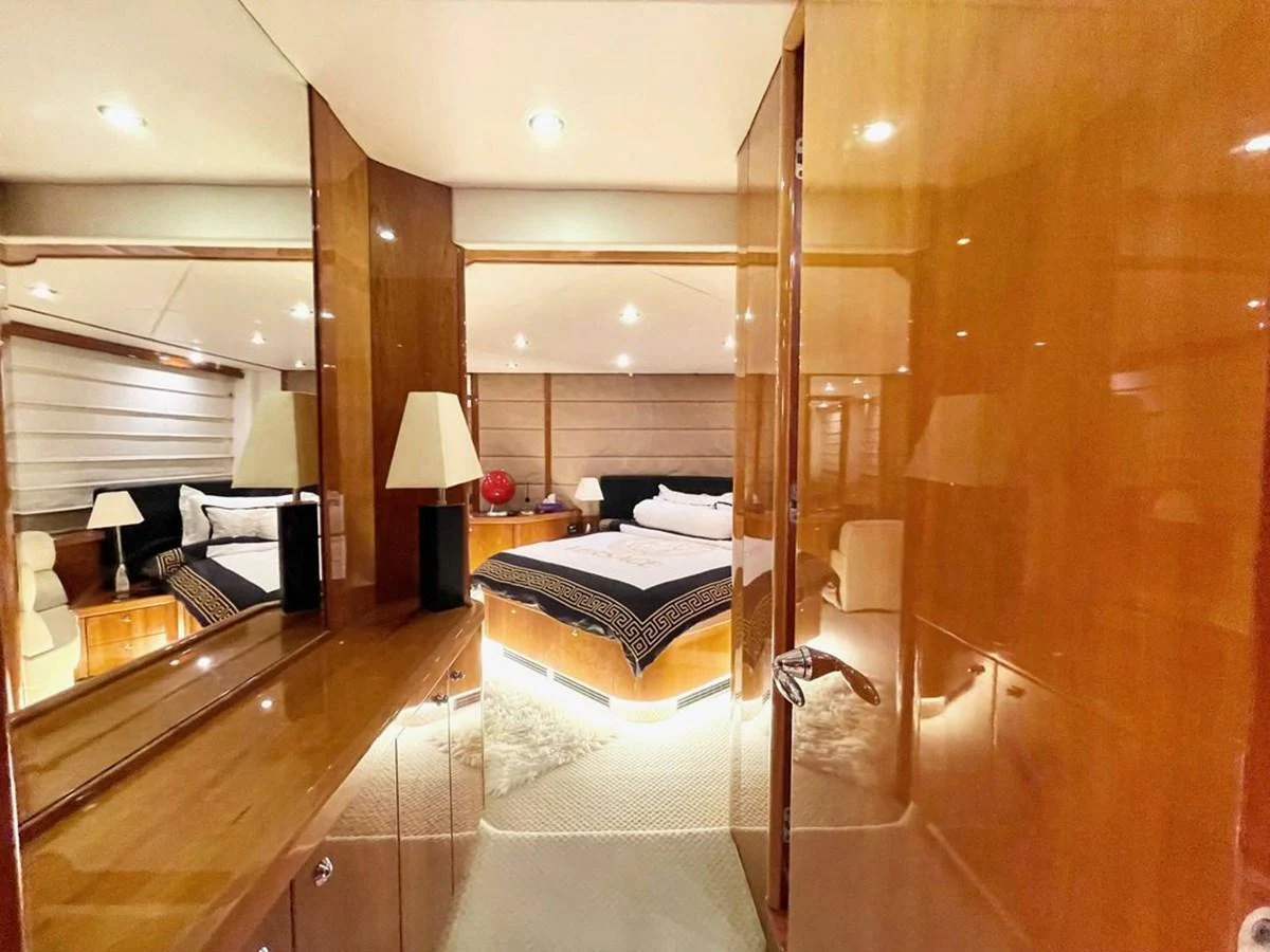 The master stateroom features luxurious wood paneling and a plush bed with elegant bedding. aboard ELLYN Yacht for Sale