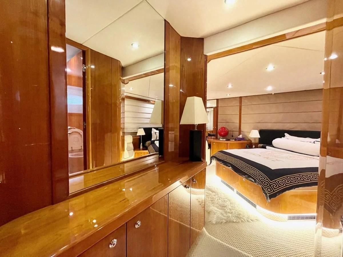 The master stateroom features luxurious wood finishes and modern lighting, creating a warm and inviting atmosphere. aboard ELLYN Yacht for Sale