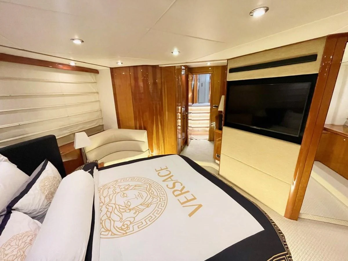 The master stateroom features luxurious bedding and elegant wood finishes. aboard ELLYN Yacht for Sale