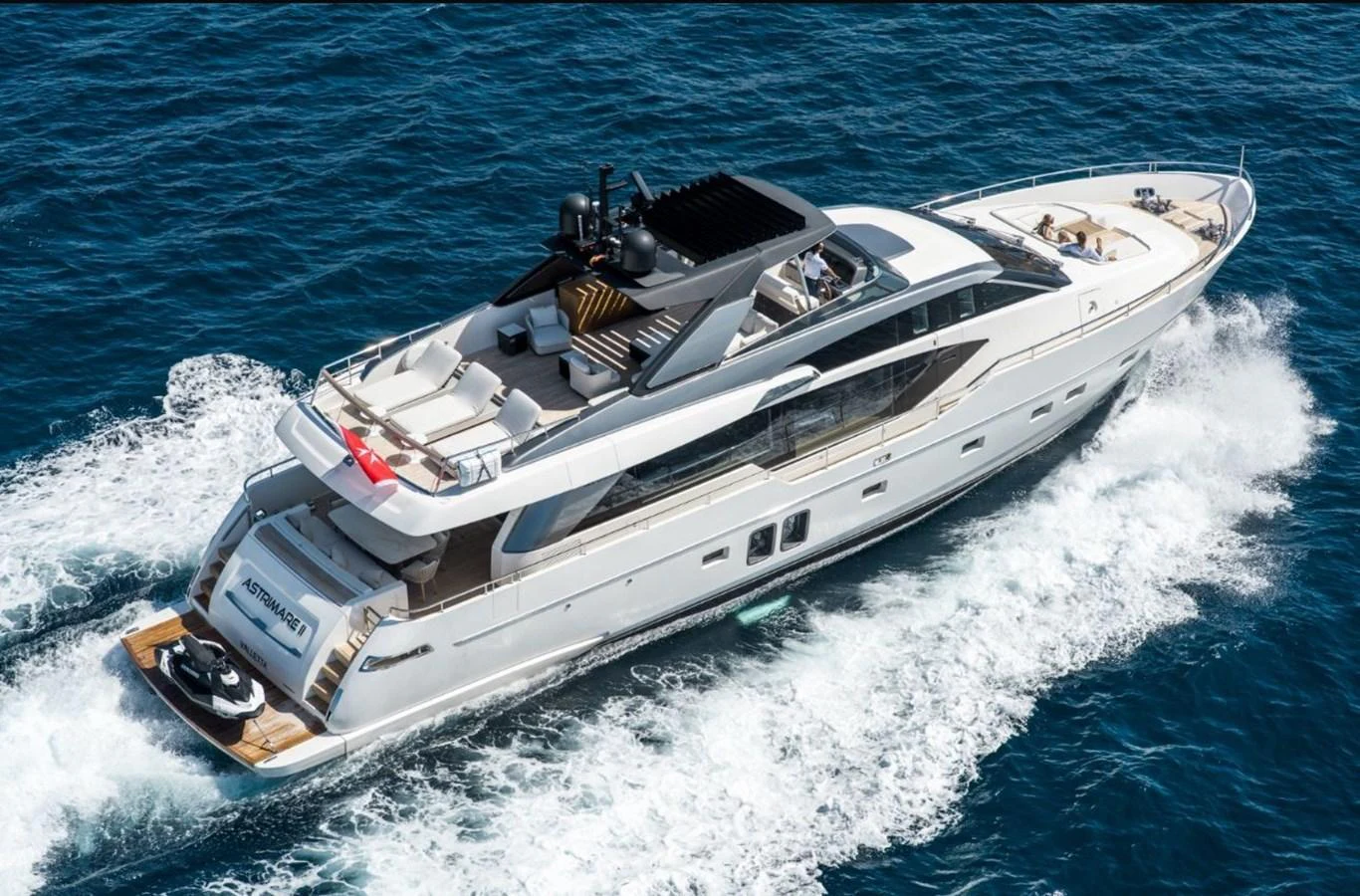 A sleek and modern yacht cruises through the open sea, showcasing its luxurious design and spacious deck areas. aboard ASTRIMARE Yacht for Sale