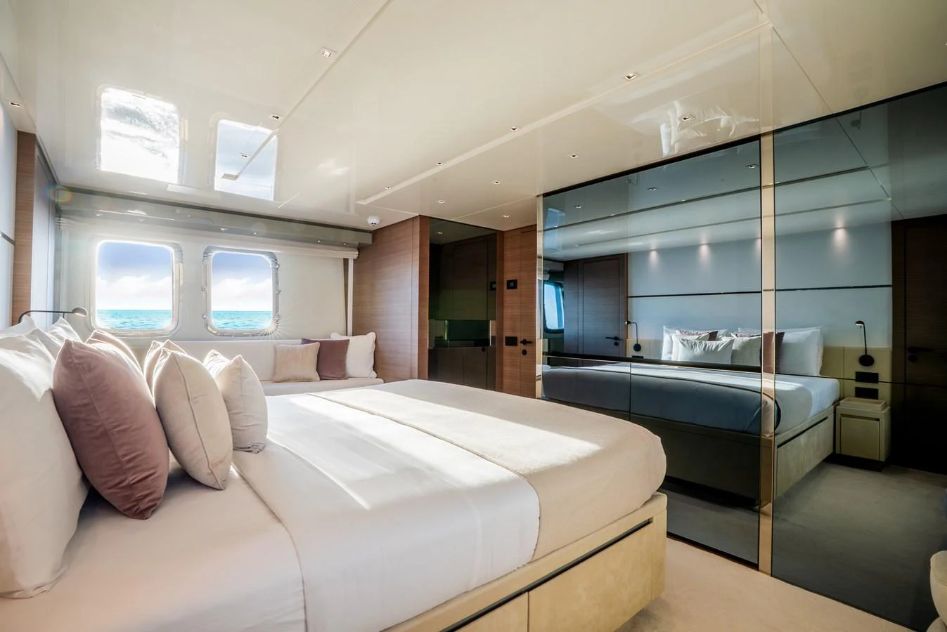 The stateroom features a luxurious bed with plush pillows and large windows offering stunning views. aboard ASTRIMARE Yacht for Sale