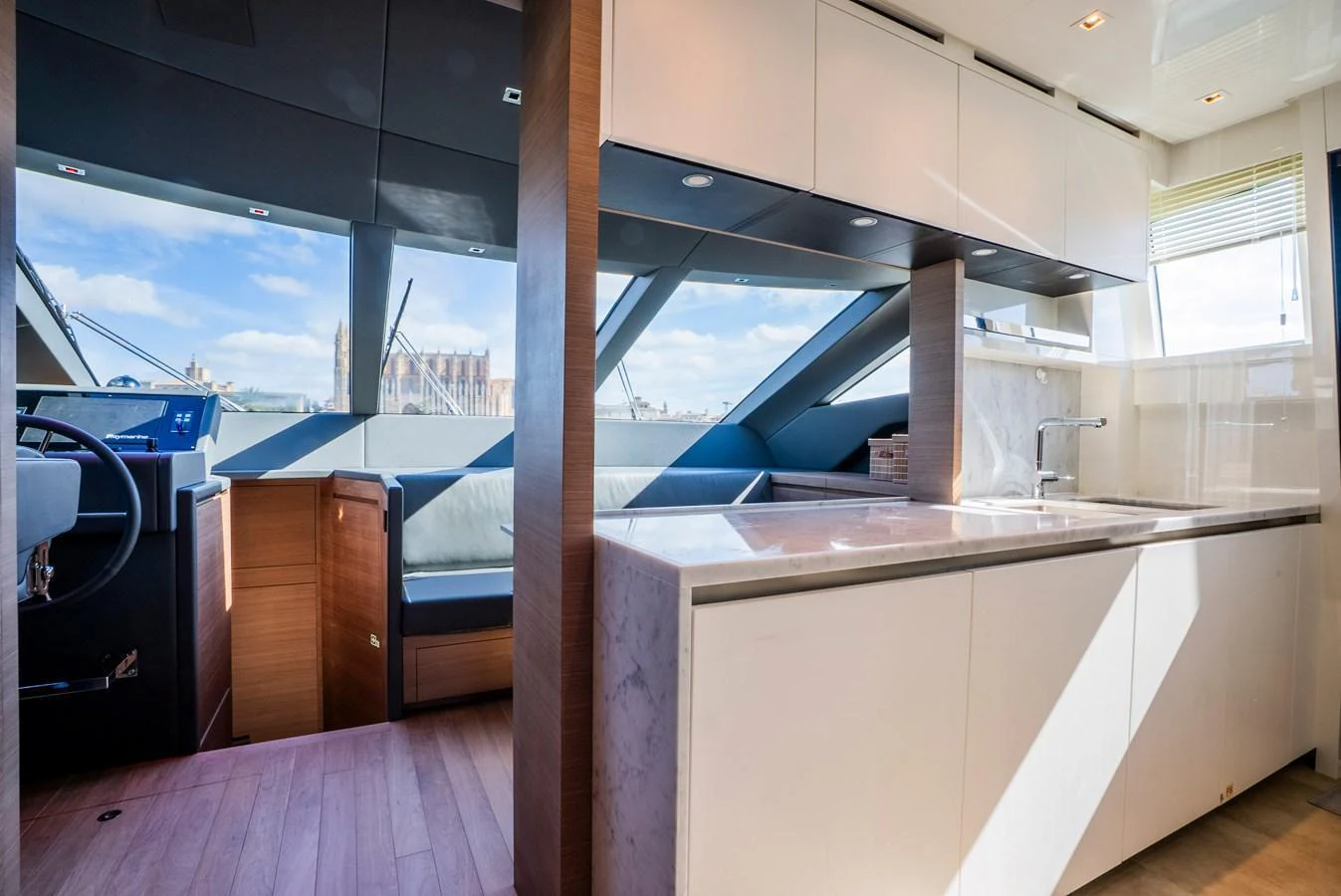 The yacht's galley features modern cabinetry, a sleek countertop, and ample natural light. aboard ASTRIMARE Yacht for Sale