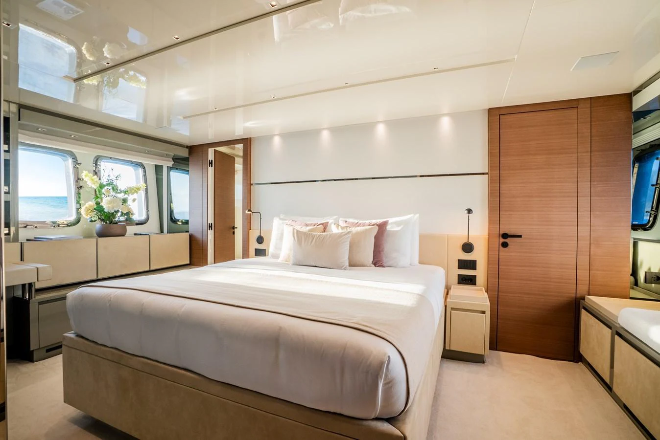 The master stateroom features a luxurious bed with ample natural light from the large windows. aboard ASTRIMARE Yacht for Sale