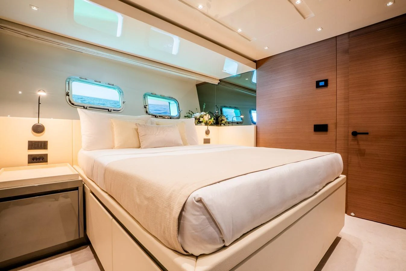 The stateroom features a luxurious bed with elegant lighting and modern decor. aboard ASTRIMARE Yacht for Sale