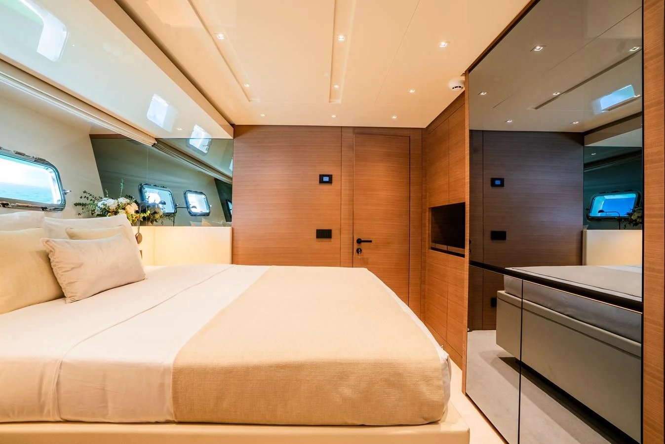 The stateroom features a luxurious bed with modern decor and ample natural light. aboard ASTRIMARE Yacht for Sale