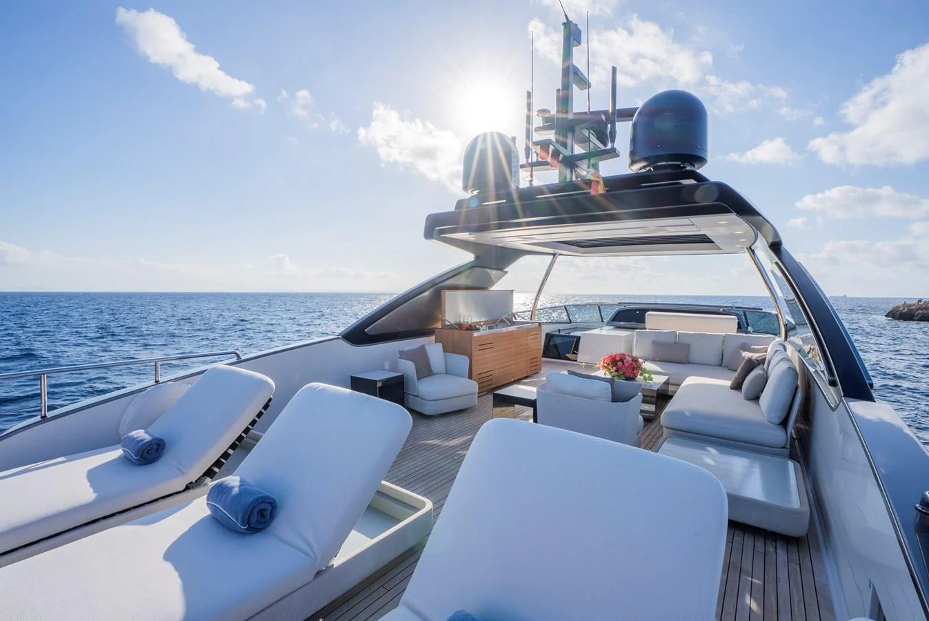 The yacht's sundeck offers luxurious lounging with plush sunbeds and a shaded seating area, perfect for relaxation. aboard ASTRIMARE Yacht for Sale