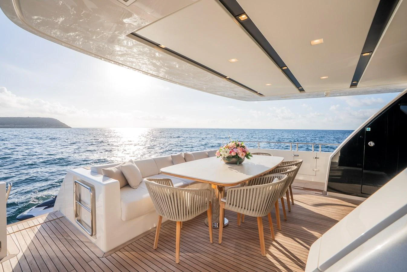 The aft deck features an elegant dining area with a stunning ocean view. aboard ASTRIMARE Yacht for Sale