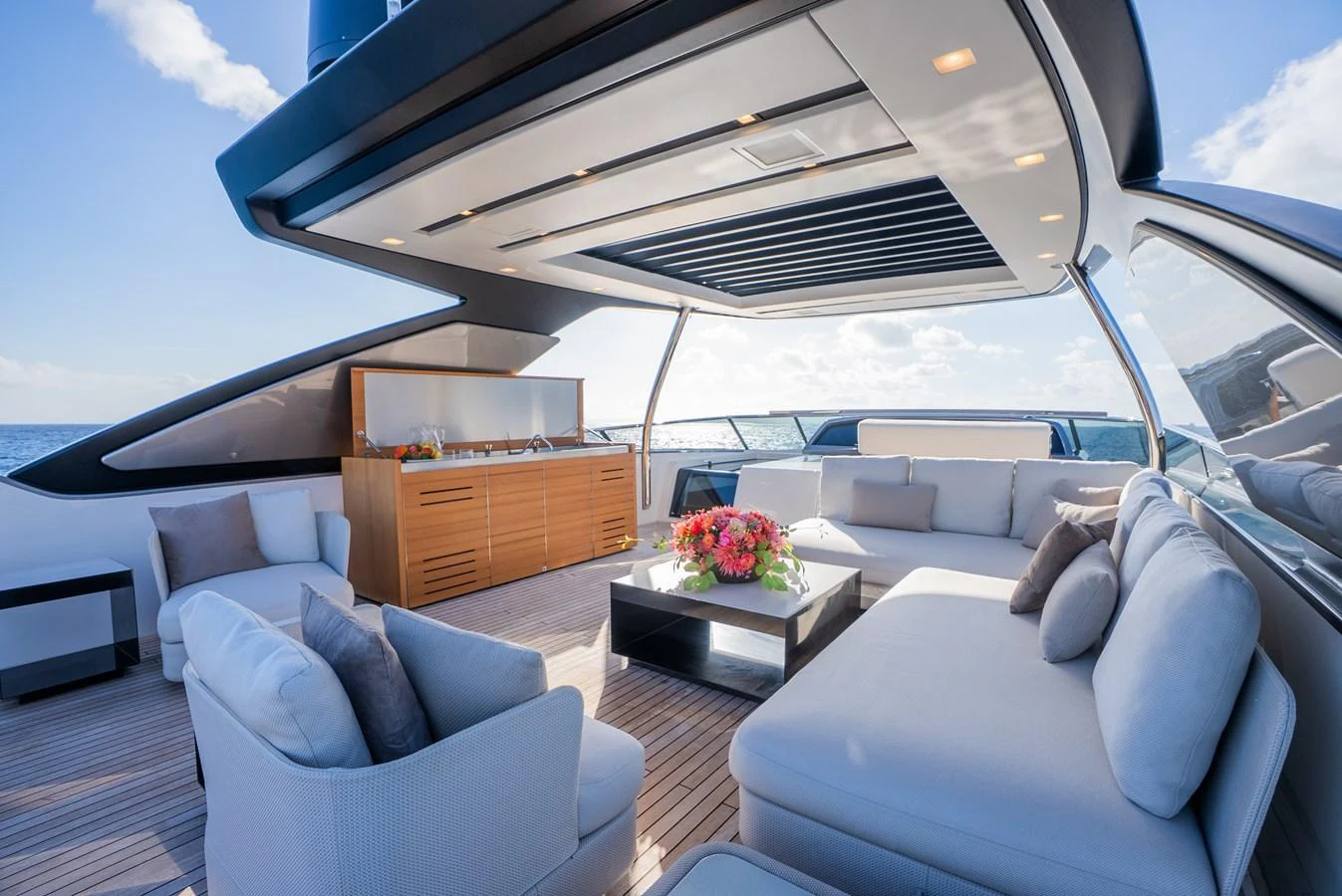 The aft deck features a luxurious seating area with plush cushions and a stylish coffee table, perfect for relaxation and socializing. aboard ASTRIMARE Yacht for Sale