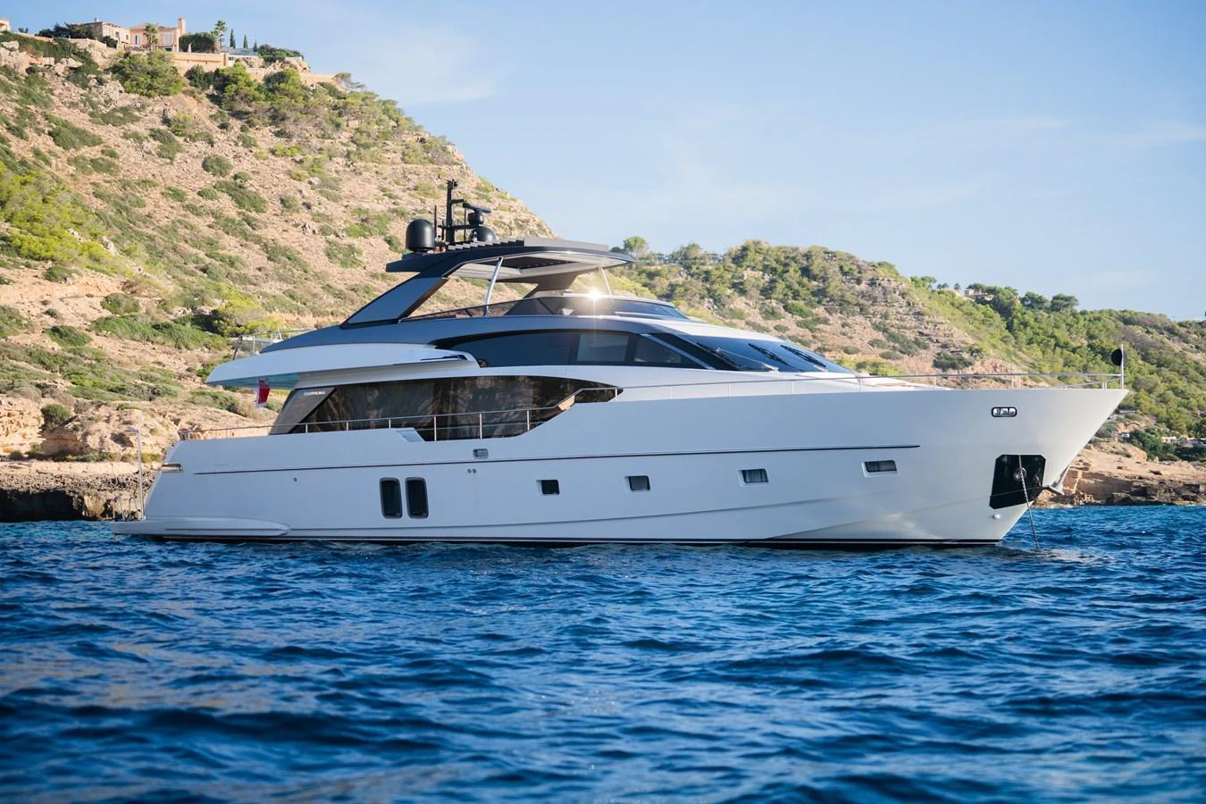 A sleek and modern yacht cruising along a scenic coastline. aboard ASTRIMARE Yacht for Sale