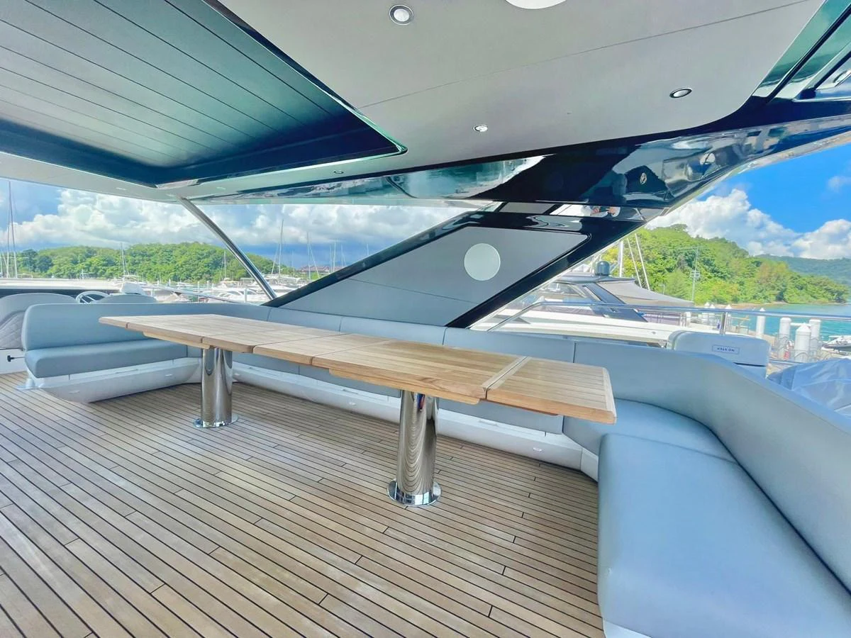 The aft deck features a spacious seating area with a large wooden table, perfect for alfresco dining. aboard SU Yacht for Sale