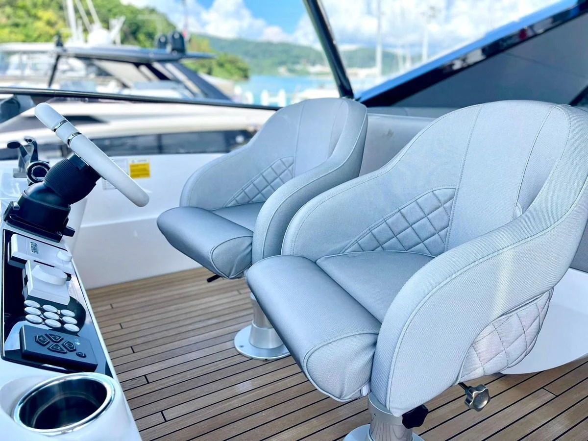 The helm area features plush, modern seating with a sleek control panel. aboard SU Yacht for Sale