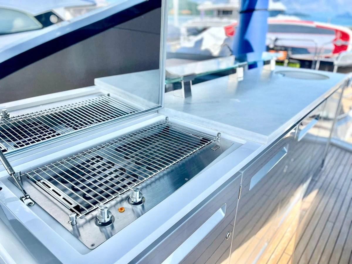This image showcases a sleek outdoor galley with a modern grill and ample counter space. aboard SU Yacht for Sale