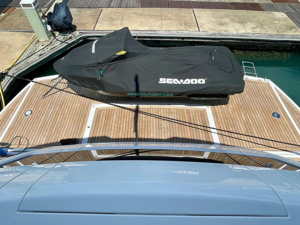 A covered Sea-Doo jet ski is securely positioned on the yacht's deck, ready for adventure. aboard SU Yacht for Sale